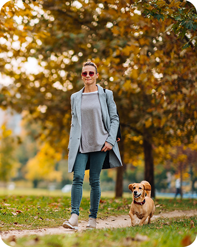 woman walking dog in park